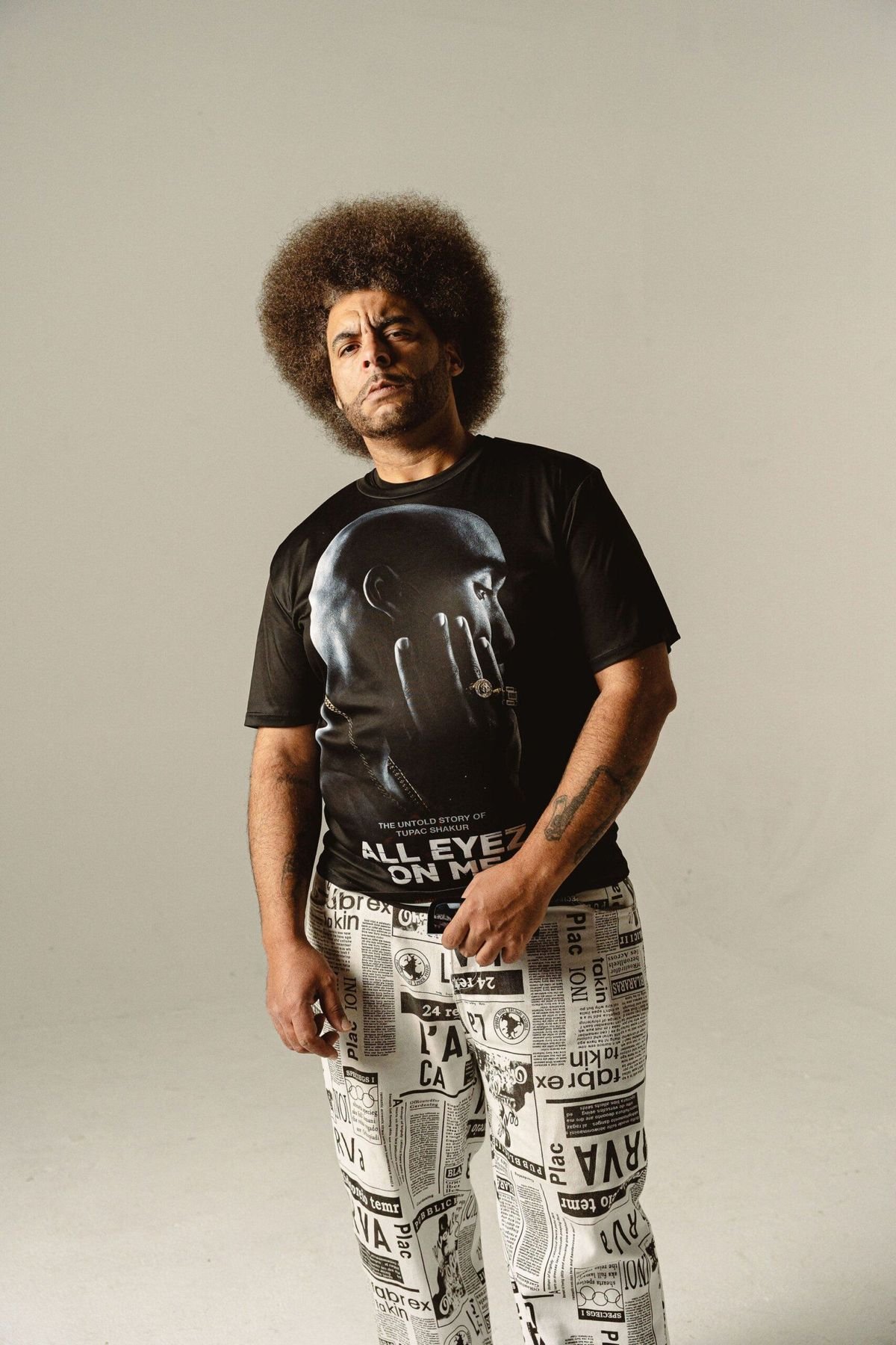 Little Moses Jones, the bandleader behind Sit With This, standing in a studio portrait